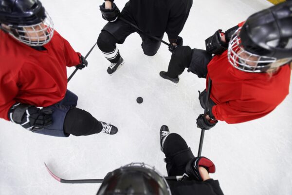 Above view background of hockey players circling pluck ready to start match on skating rink, copy space