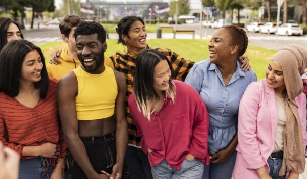 Portrait of multiracial group of friends posing in the street outdoors laughing and having fun. diverse people celebrating life together enjoying happy holidays. lifestyle, travel and joy concept